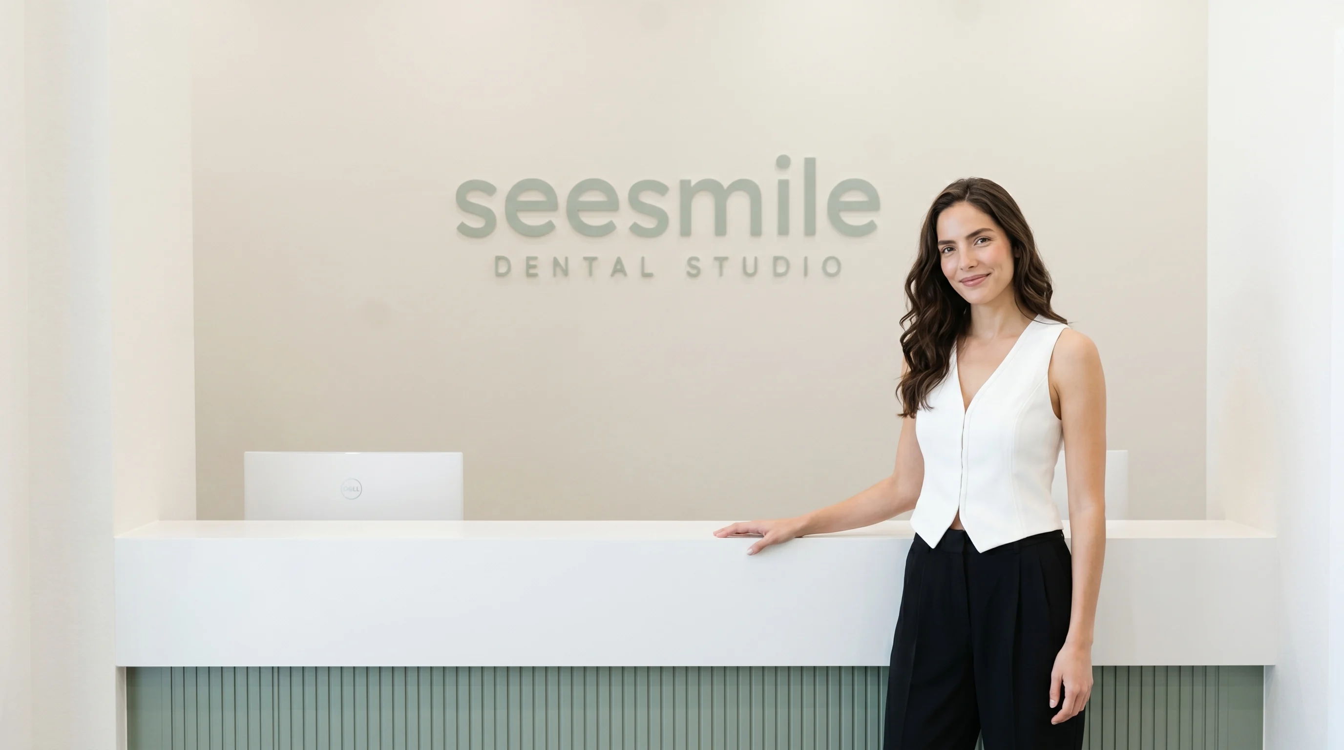 A welcoming team member at the seesmile reception desk in North York