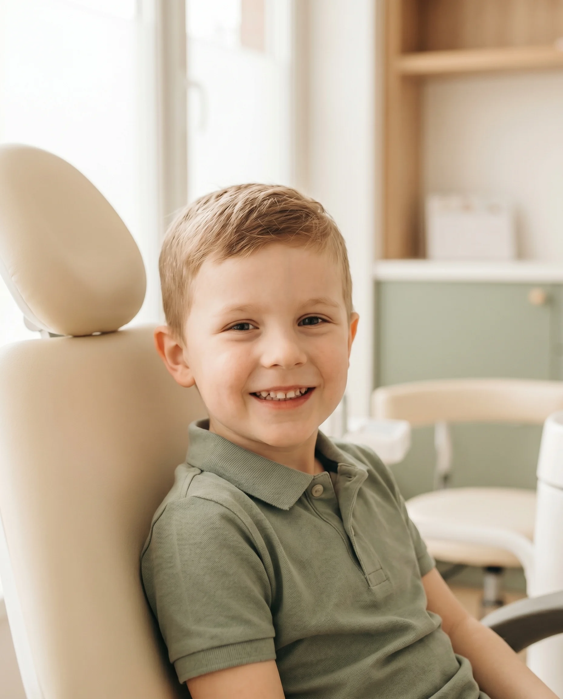 A smiling young boy in the dental chair at the seesmile studio