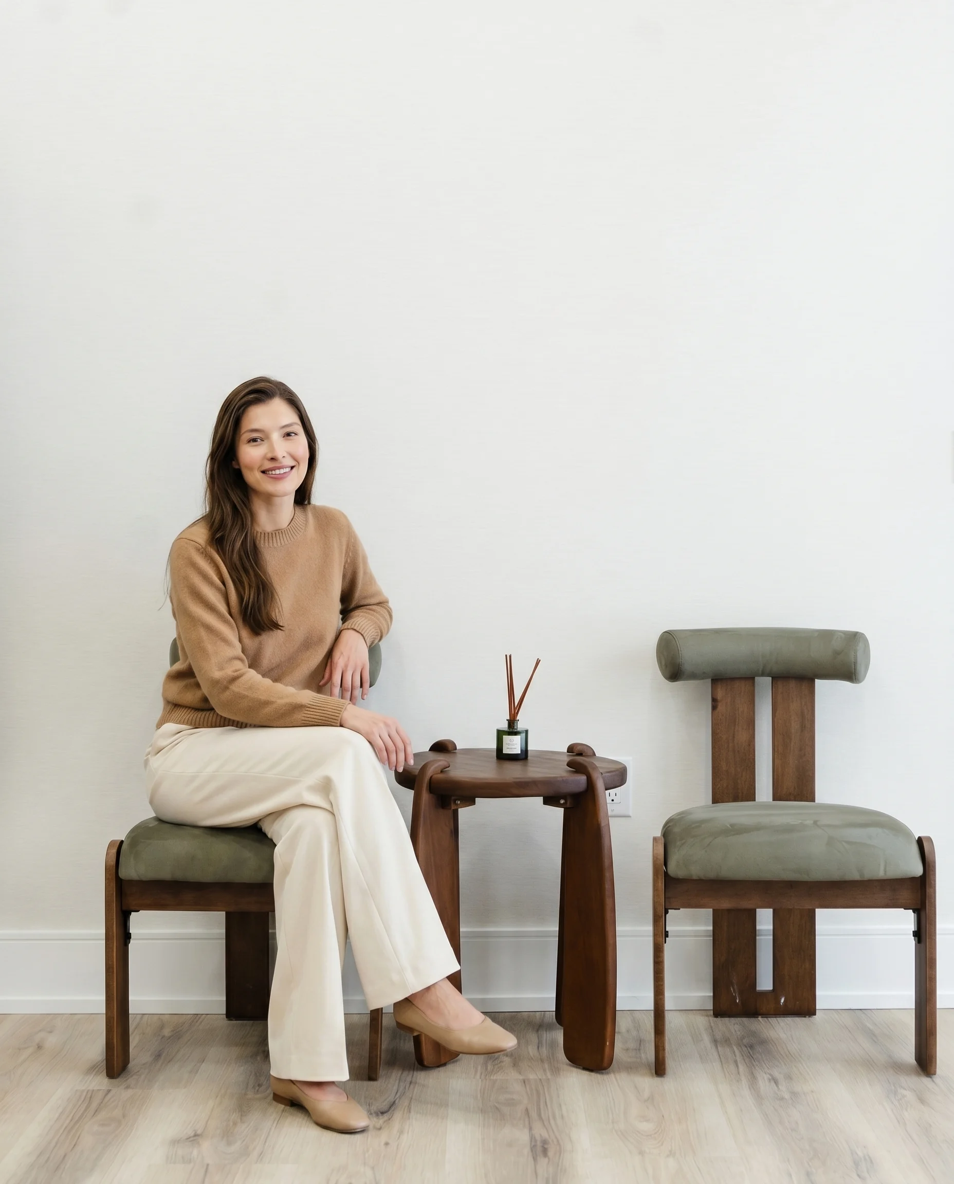 A smiling woman seated in the seesmile studio waiting area
