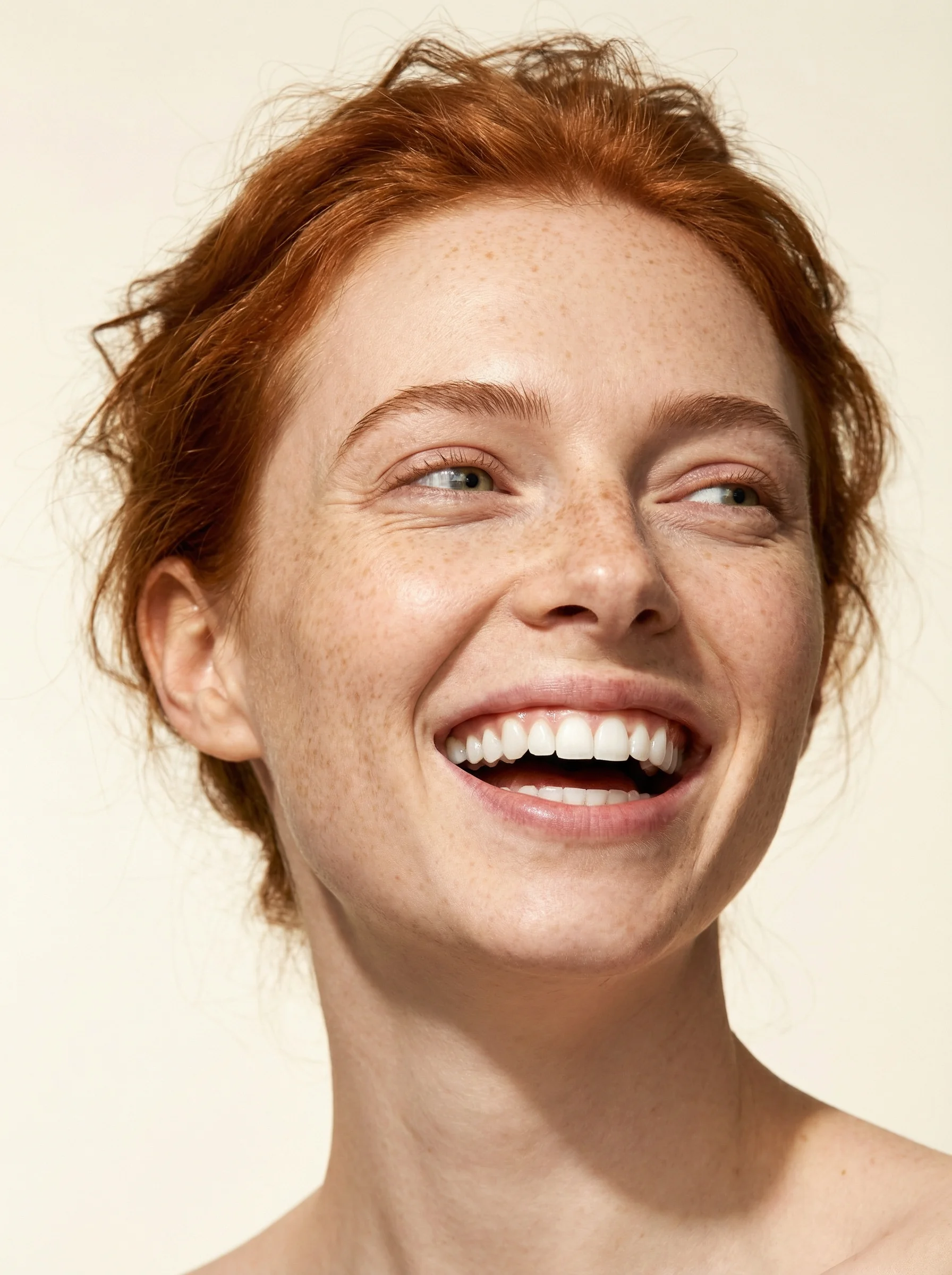 A person laughing warmly during a visit to seesmile Dental Studio